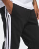 Immagine di ADIDAS - PANTALONI TUTA DA UOMO NERI  ESSENTIALS 3 - STRIPES FELPATI  -JD1861