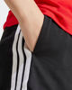Immagine di ADIDAS - PANTALONCINO DONNA NERO CON BANDE BIANCHE SINGLE JERSEY 7 POLLICI - JD0908