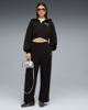 Immagine di PUMA - FELPA CON CAPPUCCIO FULL ZIP ESSENTIAL NERA GRAPHIC  DA DONNA, 635394-01